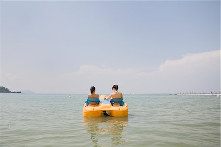 pedal boat - Two young women riding on pedal boat Stock Photo - Premium Royalty-Free, Code: 685-03081520