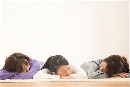 Three young women lying on floor Stock Photo - Premium Royalty-Free, Code: 685-03082166