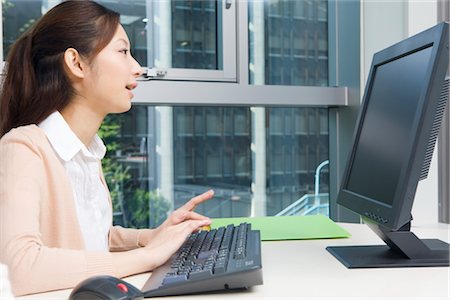 Young woman looking computer display Stock Photo - Premium Royalty-Free, Code: 685-03082238