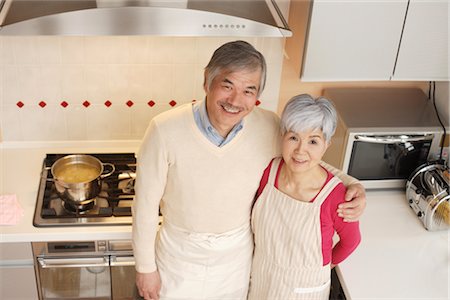 Senior couple standing in kitchen Stock Photo - Premium Royalty-Free, Code: 685-03082362