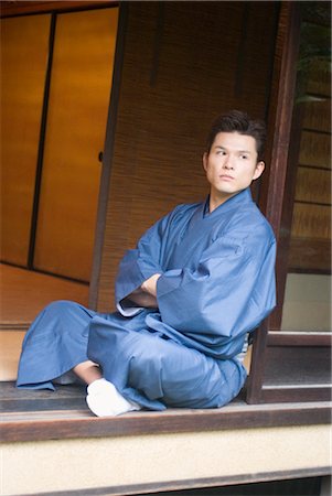 Young man in kimono sitting at veranda Stock Photo - Premium Royalty-Free, Code: 685-03082596