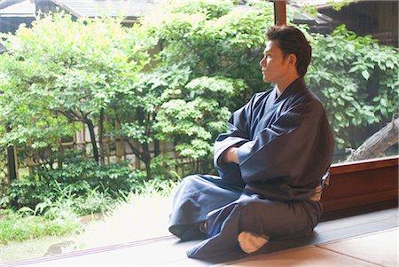 Young man in kimono sitting at veranda Stock Photo - Premium Royalty-Free, Code: 685-03082597