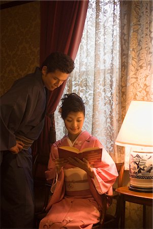 Young couple in kimono looking book Stock Photo - Premium Royalty-Free, Code: 685-03082605