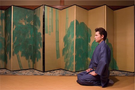 Young man in kimono sitting in front of folding screen Stock Photo - Premium Royalty-Free, Code: 685-03082600