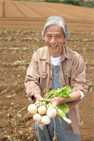 Senior man holding turnip on field Stock Photo - Premium Royalty-Free, Code: 685-03082627