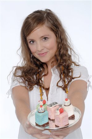 Young woman holding confectionary Stock Photo - Premium Royalty-Free, Code: 689-05610137