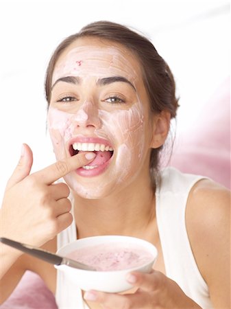 face treatment - Woman tasting fruit face mask Stock Photo - Premium Royalty-Free, Code: 689-05610293