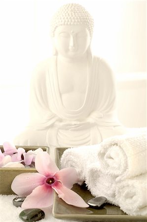 decoration flowers germany - Buddha statuette with blossoms and hematite Stock Photo - Premium Royalty-Free, Code: 689-05610300