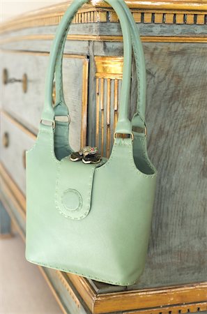 Green handbag hanging at sideboard Stock Photo - Premium Royalty-Free, Code: 689-05610678