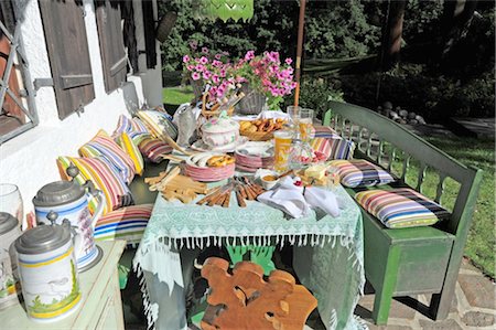 rustic flowers - Garden table and bench with cushions Stock Photo - Premium Royalty-Free, Code: 689-05610988