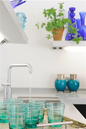 pictures of water glass and faucet - Drinking glasses at sink in kitchen Stock Photo - Premium Royalty-Free, Code: 689-05611513