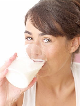 fresh face female in her thirties smiling - Young woman drinking glass of milk Stock Photo - Premium Royalty-Free, Code: 689-05611540