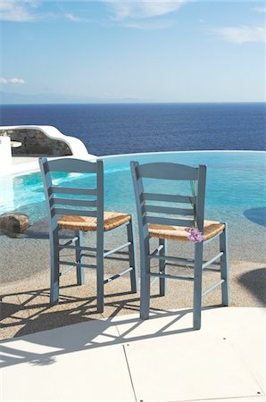 stylish swimming pool - Two chairs by the poolside above the ocean Stock Photo - Premium Royalty-Free, Code: 689-05611734