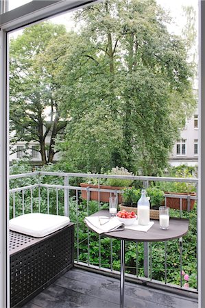 Milk, strawberries, eyeglasses and newspaper on balcony table Stock Photo - Premium Royalty-Free, Code: 689-05611806