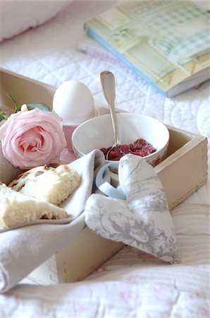 Tray with jam, egg, currant bun and rose on bed Stock Photo - Premium Royalty-Free, Code: 689-05612528