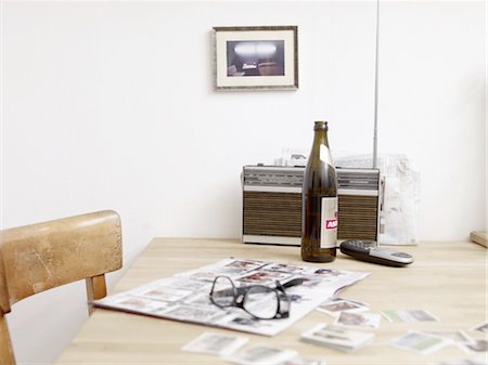 simsearch:689-05611803,k - Beer bottle, eyeglasses and album with soccer collector cards on table Stock Photo - Premium Royalty-Free, Code: 689-05612556