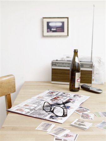 Beer bottle, eyeglasses and album with soccer collector cards on table Stock Photo - Premium Royalty-Free, Code: 689-05612550