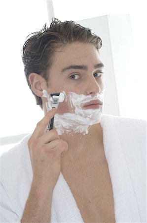 routine - Young man in bathrobe shaving Stock Photo - Premium Royalty-Free, Code: 689-05612611