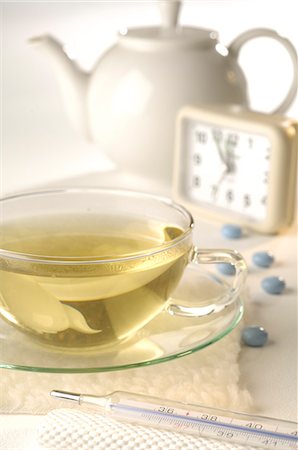 Tea with clinical thermometer,alarm clock,pills and teapot Stock Photo - Premium Royalty-Free, Code: 689-03124335