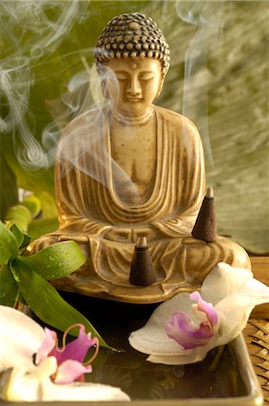 Buddha with incense cone and orchid blossoms Stock Photo - Premium Royalty-Free, Code: 689-03124407