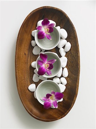 dendrobium orchid - Wooden bowl decorated with pebbles and flowers in porcellain bowls Stock Photo - Premium Royalty-Free, Code: 689-03124838