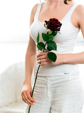 simsearch:689-03124881,k - Model holding red rose Stock Photo - Premium Royalty-Free, Code: 689-03124897