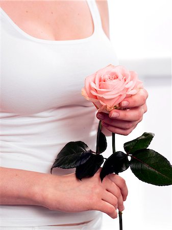 simsearch:689-03124881,k - Model holding pink rose Stock Photo - Premium Royalty-Free, Code: 689-03124902