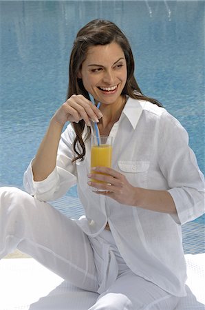 simsearch:689-03124937,k - Woman dressed in white enjoying a drink at the swimming pool Fotografie stock - Premium Royalty-Free, Codice: 689-03125032