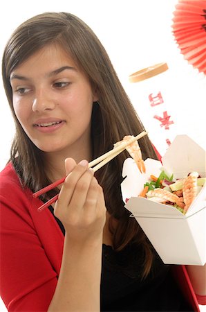 simsearch:689-03124356,k - Woman is eating shrimps in a lunch box with chopsticks Stock Photo - Premium Royalty-Free, Code: 689-03125569