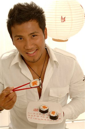 simsearch:689-03124356,k - Man is eating sushi with chopsticks Stock Photo - Premium Royalty-Free, Code: 689-03125577