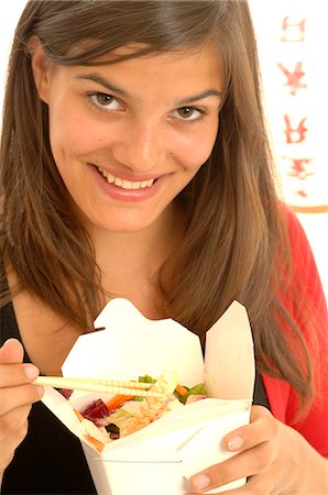 people eating seafood - Woman is eating Asian food with chopsticks Stock Photo - Premium Royalty-Free, Code: 689-03125571
