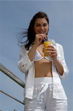 simsearch:689-03124937,k - Woman dressed in white enjoying a drink at the swimming pool Fotografie stock - Premium Royalty-Free, Codice: 689-03126524