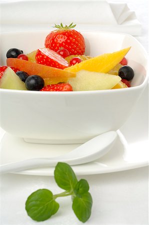 strawberries in salad - Fruit salad in a white porcelain bowl Stock Photo - Premium Royalty-Free, Code: 689-03126801