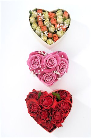 symbol present - Three heartshape boxes filled with rose blossoms Stock Photo - Premium Royalty-Free, Code: 689-03127146
