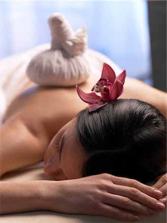 spa model - Woman getting a massage with a compress Stock Photo - Premium Royalty-Free, Code: 689-03127293
