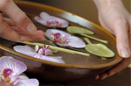 spa decoration - Hand bath with orchid blossoms ad limes Stock Photo - Premium Royalty-Free, Code: 689-03127753