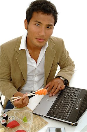 simsearch:689-03124356,k - Asian man eating sushi at the desk Stock Photo - Premium Royalty-Free, Code: 689-03128590