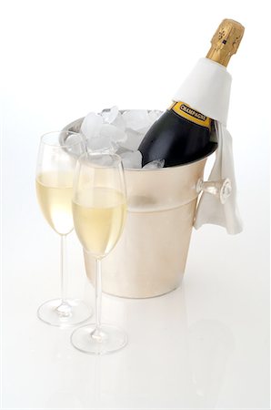 picture of champagne bottle and champagne flute - Champagne bottle in an ice bucket and two champagne glasses Stock Photo - Premium Royalty-Free, Code: 689-03129166