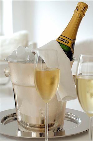 picture of champagne bottle and champagne flute - Champagne bottle in an ice bucket and two champagne glasses Stock Photo - Premium Royalty-Free, Code: 689-03129171