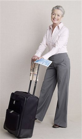 stockbroker - Senior adult with a bag,newspaper and flight ticket Stock Photo - Premium Royalty-Free, Code: 689-03129290