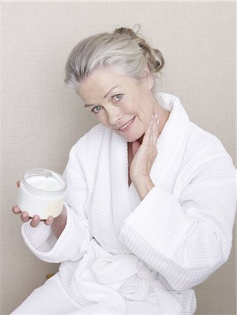 elderly woman beauty - Senior adult in bathrobe holding body cream Stock Photo - Premium Royalty-Free, Code: 689-03129307
