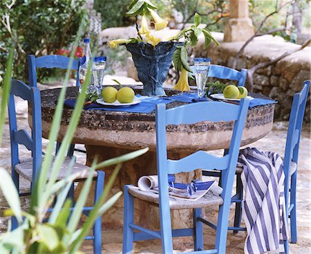 rural scene table - Rustic-style table with blue chairs Stock Photo - Premium Royalty-Free, Code: 689-03130367