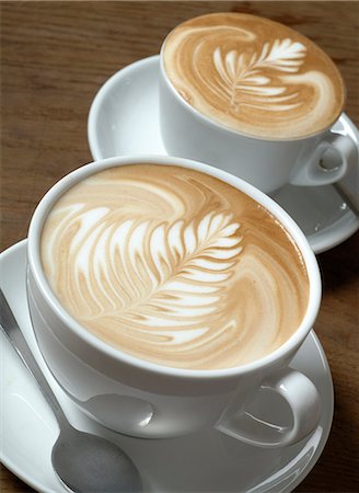 simsearch:600-03406503,k - Two cappuccini with milk froth ornaments Stock Photo - Premium Royalty-Free, Code: 689-03130685