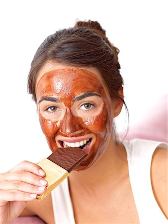 flavour balance - Dark-haired woman with Chocolate mask eating chocolate Stock Photo - Premium Royalty-Free, Code: 689-03130828