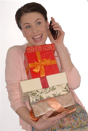 people shocked on phones - Brunette with mobile and presents Stock Photo - Premium Royalty-Free, Code: 689-03130920