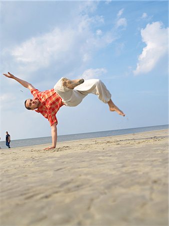 simsearch:689-03130965,k - Impressive jump on the beach Stock Photo - Premium Royalty-Free, Code: 689-03131069