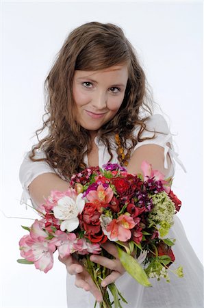 Woman holding bunch of flowers Stock Photo - Premium Royalty-Free, Code: 689-03733006