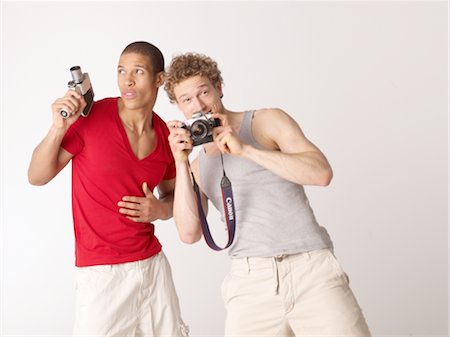 Two friends with camcorder and camera Stock Photo - Premium Royalty-Free, Code: 689-03733192