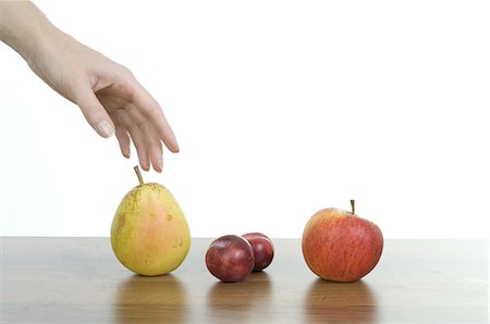 simsearch:6111-06728885,k - Woman's hand reaching for pear Stock Photo - Premium Royalty-Free, Code: 689-03733248