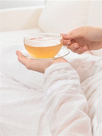 drinking healthy tea - Hand holding cup of calming tea Stock Photo - Premium Royalty-Free, Code: 689-03733364